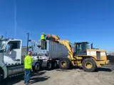 Biosolids hauling semi truck being loaded by front end loader.